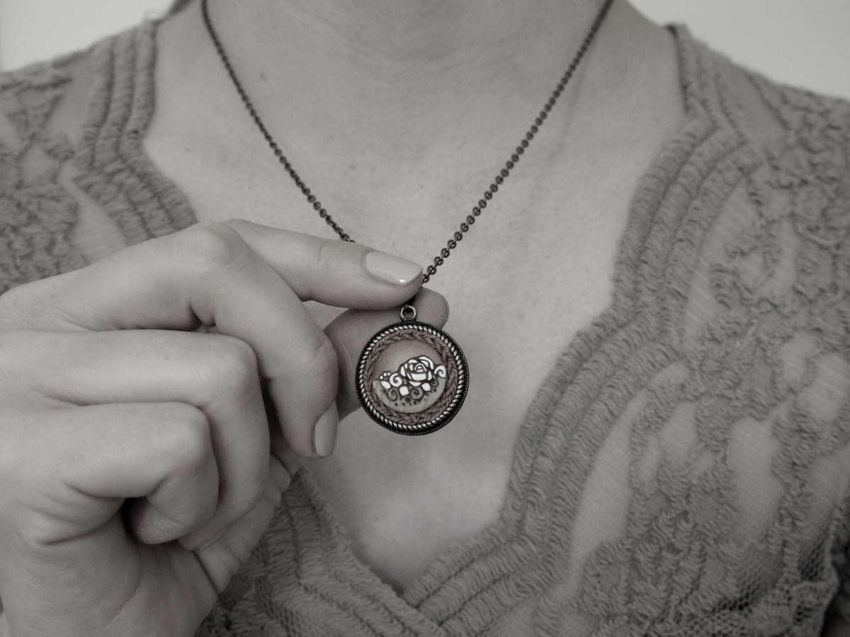 small round wooden necklace rose design on model