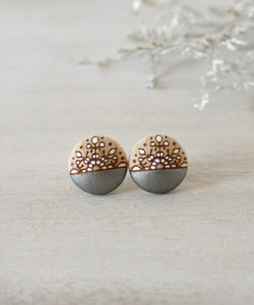 small silver wooden earrings on background