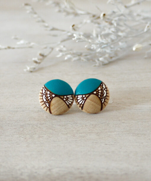 small turquoise wooden earrings on background