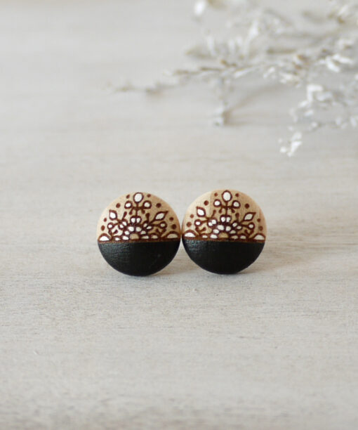 unique wooden earrings in black color small on background