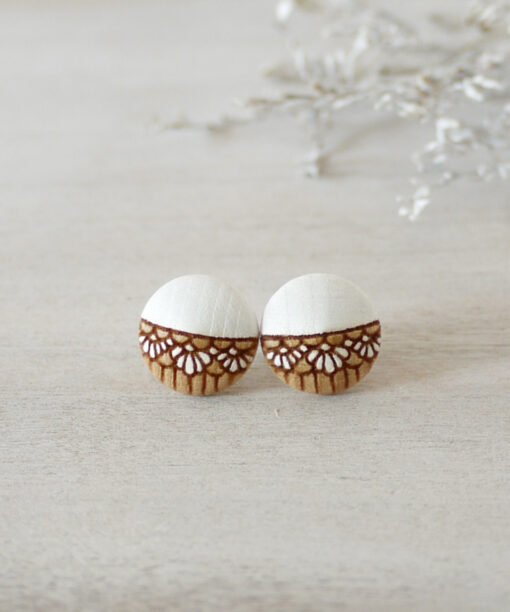 small white wooden earrings on background
