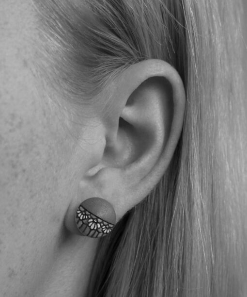 small wooden earrings daisy design on model