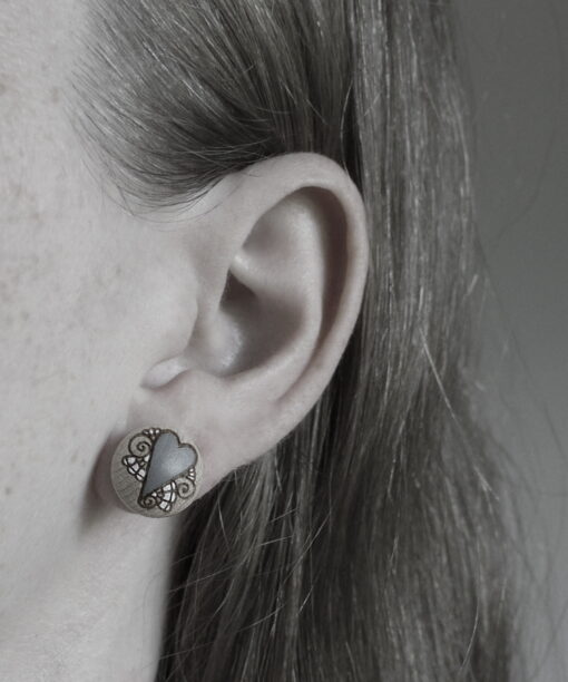 small wooden earrings heart design on model