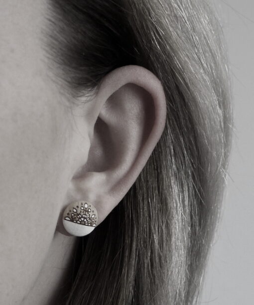 small wooden earrings snowflake design on model
