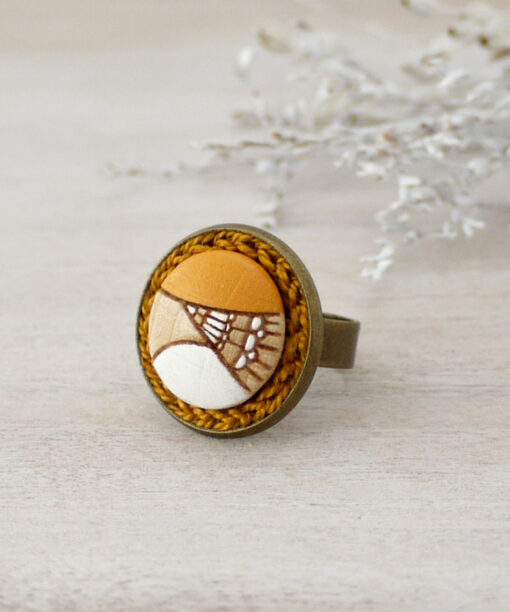 small yellow wooden ring on background
