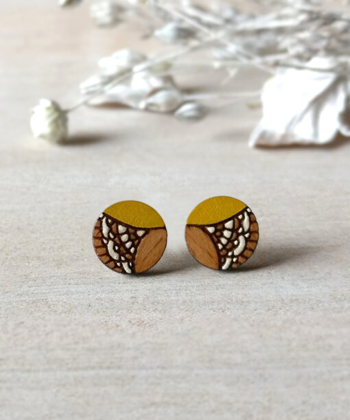 yellow wooden earrings mini round on background