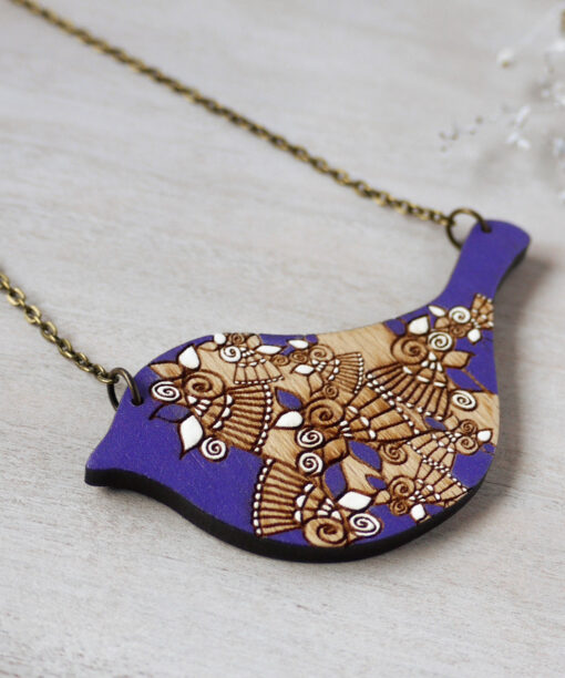 bird purple wooden necklace on background