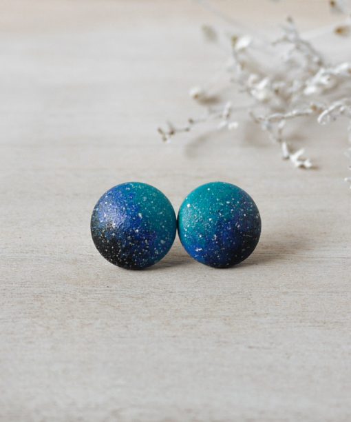 small blue night sky wooden earrings on background