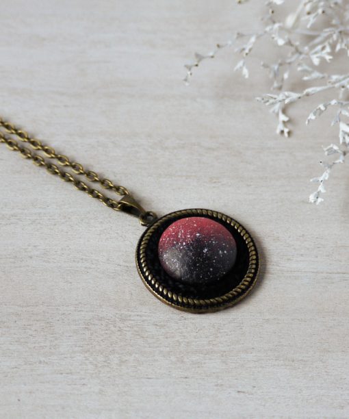 small pink night sky wooden necklace on background