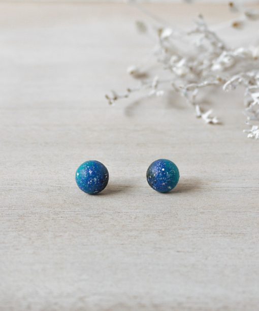 tiny blue night sky wooden earrings on background