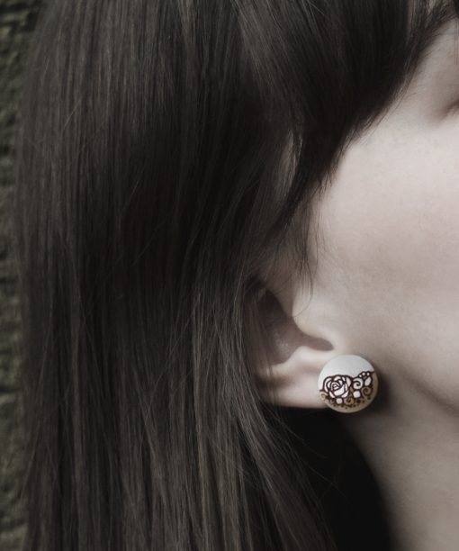 small wooden earrings rose design on model