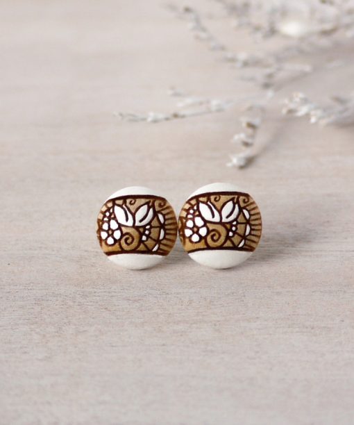 small wooden earrings in white color on background
