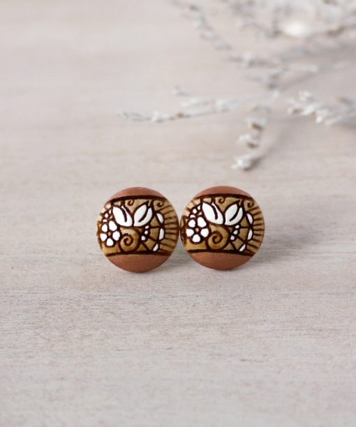small wooden studs in rose gold color on background