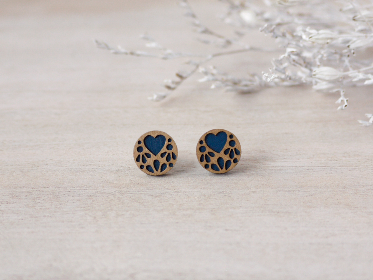 blue lace wooden earrings on background