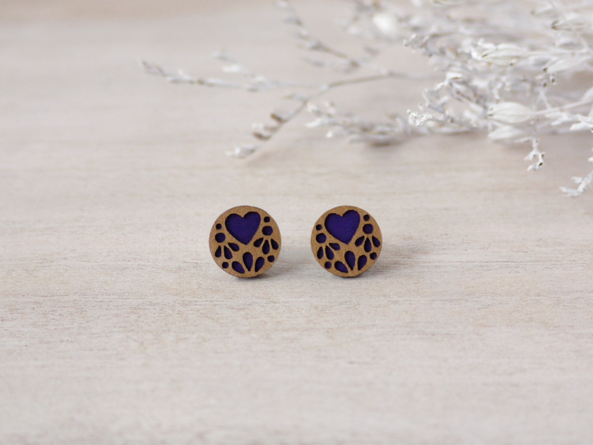 purple lace wooden earrings on background