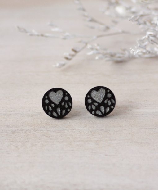 silver lace wooden earrings on background