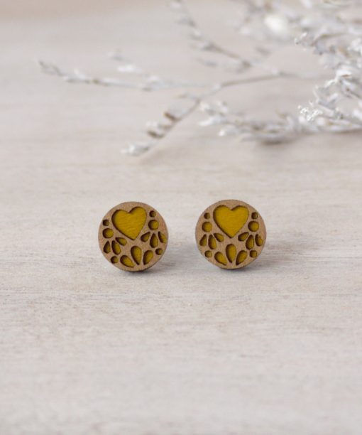 yellow lace wooden earrings on background