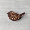 bird brown wooden brooch on background