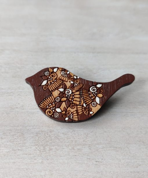 bird brown wooden brooch on background