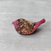 bird pink wooden brooch on background