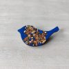 bird royal blue wooden brooch on background