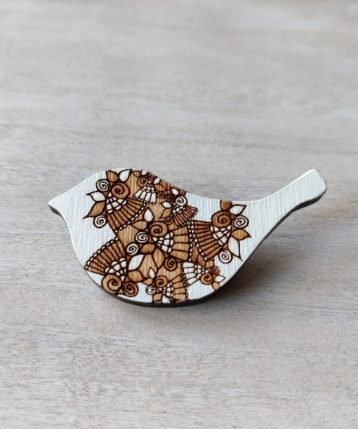 bird white wooden brooch on background