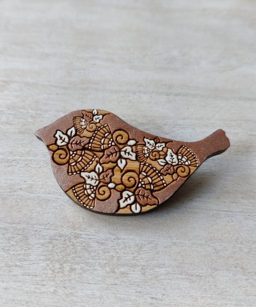 rose gold wooden brooch bird on background